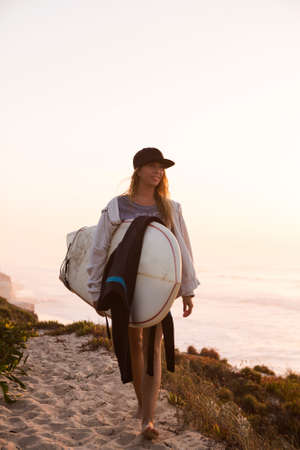 Beautiful female Surfer looking for the waves