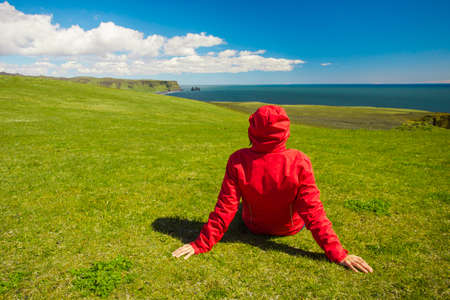 Woman sitting on the grass enjoying the natureの写真素材