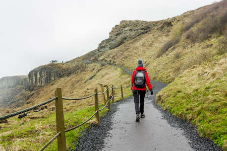 Shoot of a hiker woman walking at mountains in the winterの写真素材