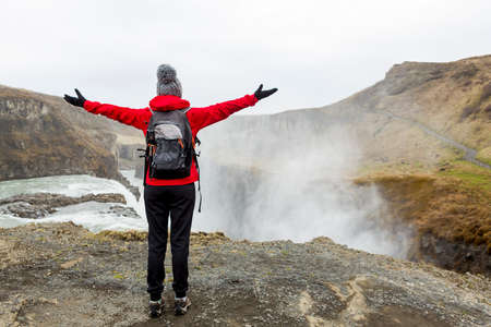 Female backpacker tourist in Iceland watching a waterfallの写真素材