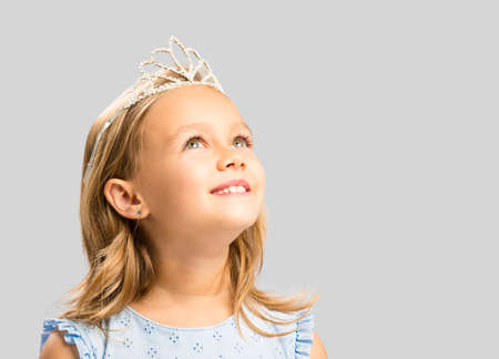 Portrait of a cute happy little girl wearing a princess crownの写真素材