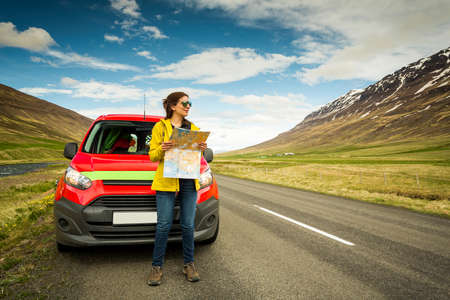 Female tourist watching a map and finding the right way