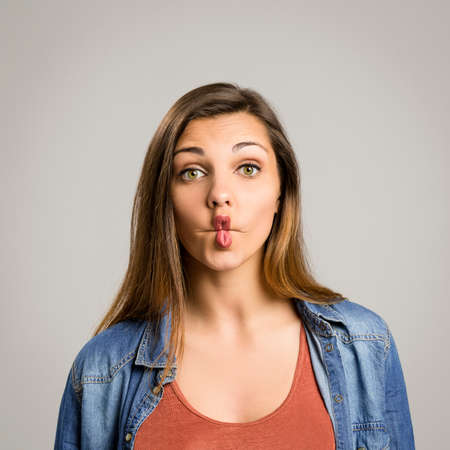 Portrait of a beautiful woman making a pout expressionの写真素材