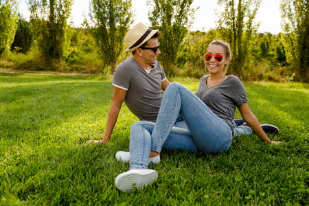 Portrait of a happy young couple enjoying a day in the park togetherの写真素材