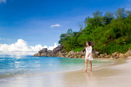 Beautiful woman enjoying the beautiful beachs of Praslin, Seychellesの写真素材