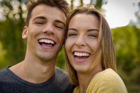 Portrait of a young beautiful couple laughingの写真素材