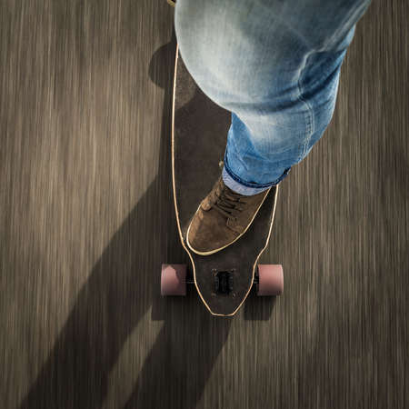 Detail of a young man feet riding a skateboardの写真素材