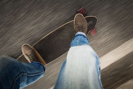 Detail of a young man feet riding a skateboardの写真素材