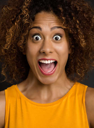 Portrait of a beautiful African American woman after receiving good newsの写真素材