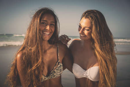 Best friends having fun on the beachの写真素材