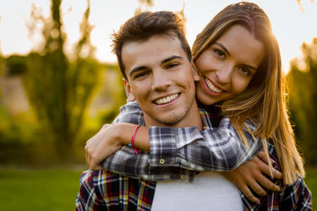 Portrait of a happy young couple in the nature hugged together