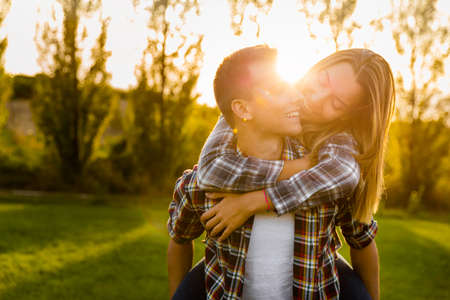 Portrait of a happy young couple in the nature hugged togetherの写真素材