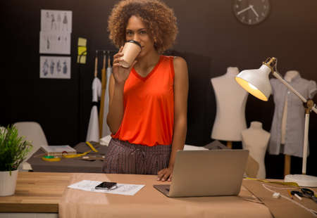 A young fashion designer working on her atelier