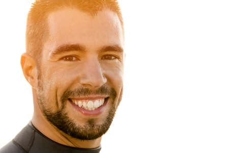 Outdoor portrait of an handsome young surfist smilingの写真素材