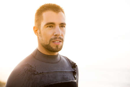 Outdoor portrait of an handsome young surfist smilingの写真素材
