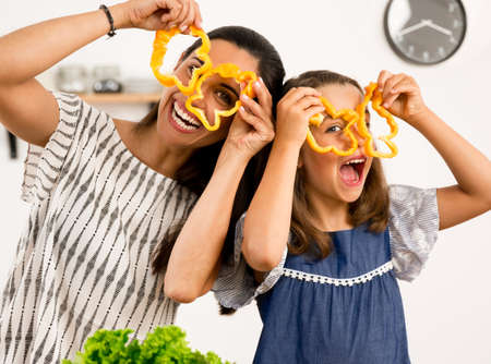Shot of a mother and daughter having fun in the kitchenの写真素材