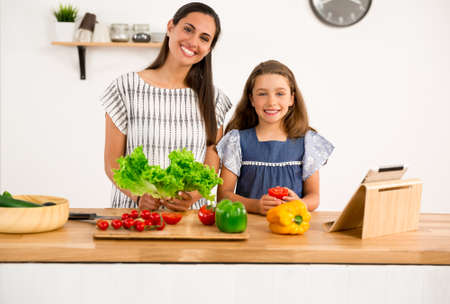Shot of a mother and daughter having fun in the kitchenの写真素材