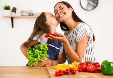 Shot of a mother and daughter having fun in the kitchenの写真素材