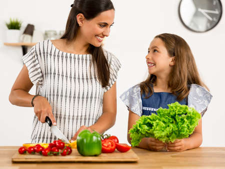 Shot of a mother and daughter having fun in the kitchenの写真素材