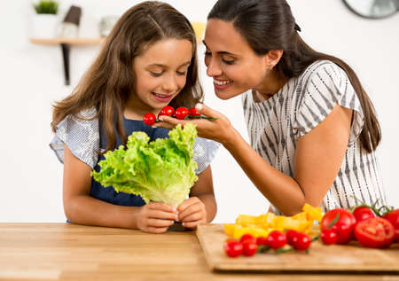 Shot of a mother and daughter having fun in the kitchenの写真素材