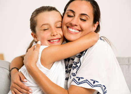 Beautiful Mom and Daughter having fun at home