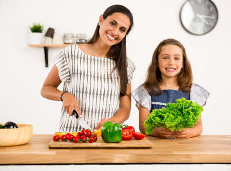 Shot of a mother and daughter having fun in the kitchenの写真素材