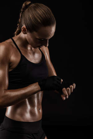 Shot of a beautiful fit young woman getting ready for a kickbox workoutの写真素材