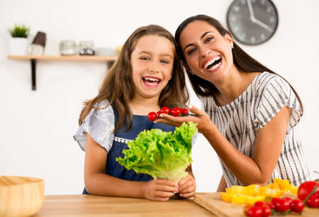 Shot of a mother and daughter having fun in the kitchenの写真素材