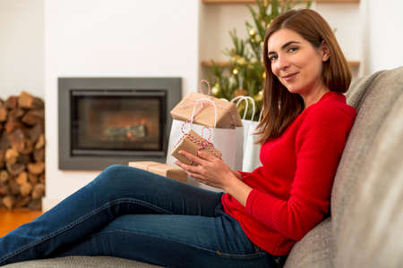 Beautiful woman at home making the last things for Christmasの写真素材