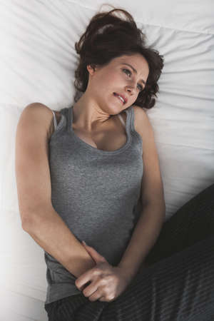 Young girl in pain with PMS, Premenstural Syndromeの写真素材