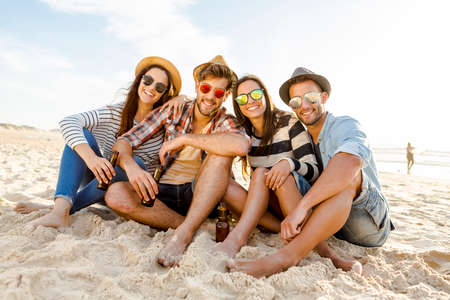 Friends at the beach enjoying the summerの写真素材