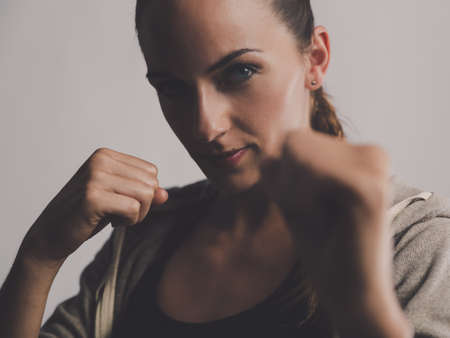 Shot of a beautiful young woman practicing kickboxingの写真素材