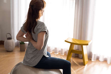 Shot of a woman doing exercise at homeの写真素材