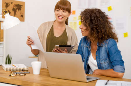 Shot of two businesswoman working together in an office