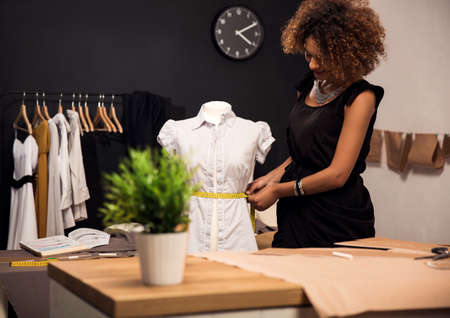 Young fashion designer working on her atelierの写真素材