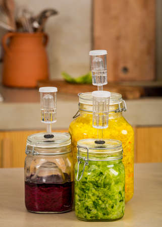 Preparing fermented preserved vegetables. Jars of cabbage kimchi and sauerkraut sour cabbage. 