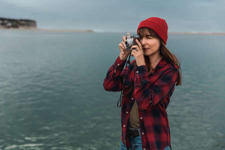 Beautiful woman enjoying her day taking pictures with her cameraの写真素材