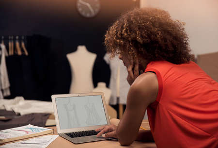 A young fashion designer working on her atelier