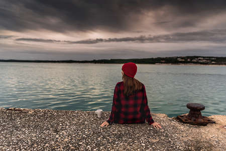 Beautiful woman enjoying her day in the lake with a mug of hot coffee
