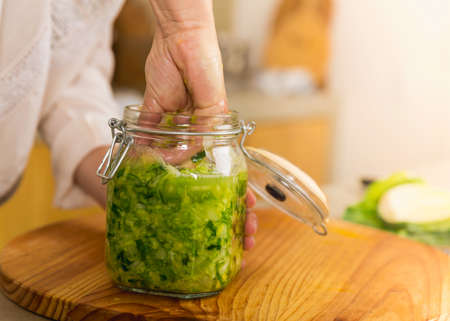 Preparing fermented preserved vegetables. Jars of cabbage kimchi and sauerkraut sour cabbage. 