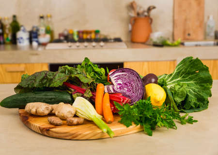 Several vegetables on top of a wooden board. Ingredients for detox diet. の写真素材