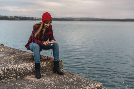 Beautiful woman enjoying her day taking pictures with her camera