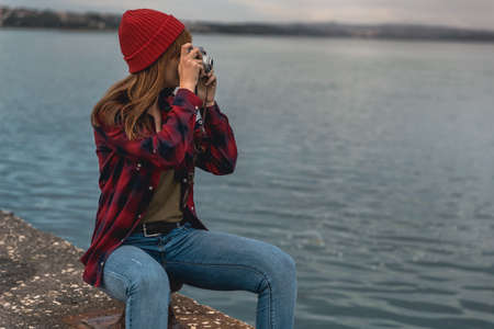 Beautiful woman enjoying her day taking pictures with her cameraの写真素材