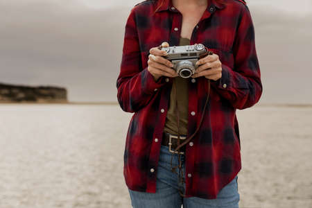 Beautiful woman enjoying her day taking pictures with her camera