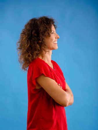 Portrait of a beautiful woman over a blue backgroundの写真素材