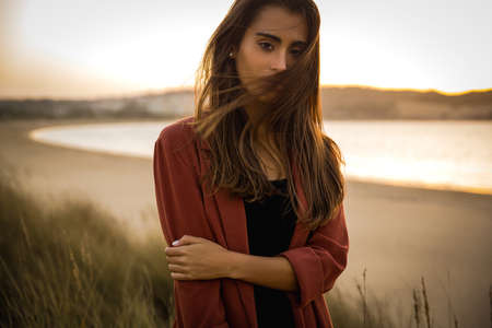 Outdoor portrait of a beautiful young woman at the beach
