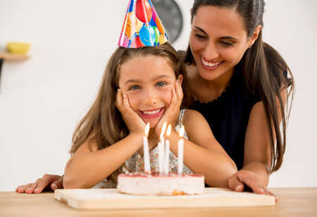 Shot of a mother and daughter in the kitchen celebrating Daughter's birthday