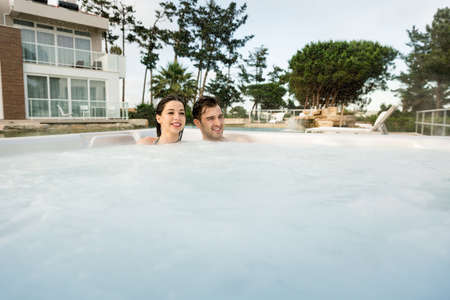 Young couple in a luxury hotel inside a bathtub in a rainy day の写真素材