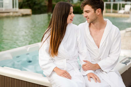 Young couple sitting near a hot tub in a luxury hotel