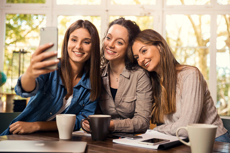 Groups of female firends making a selfie during a pause on the studiesの写真素材